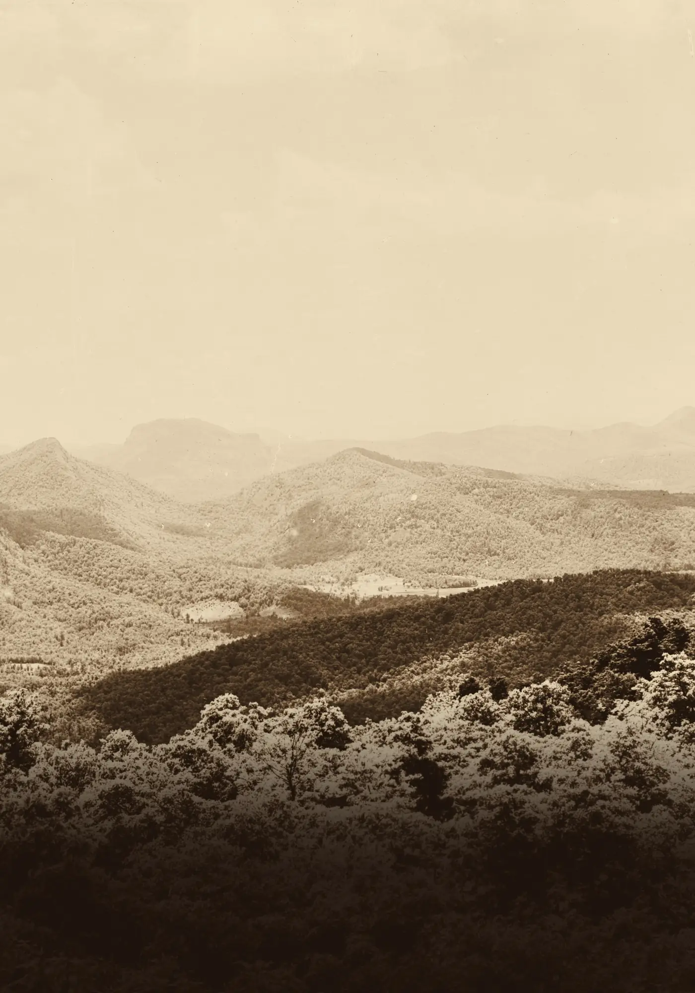 Sepia photograph of hazy, layered Blue Ridge mountains.